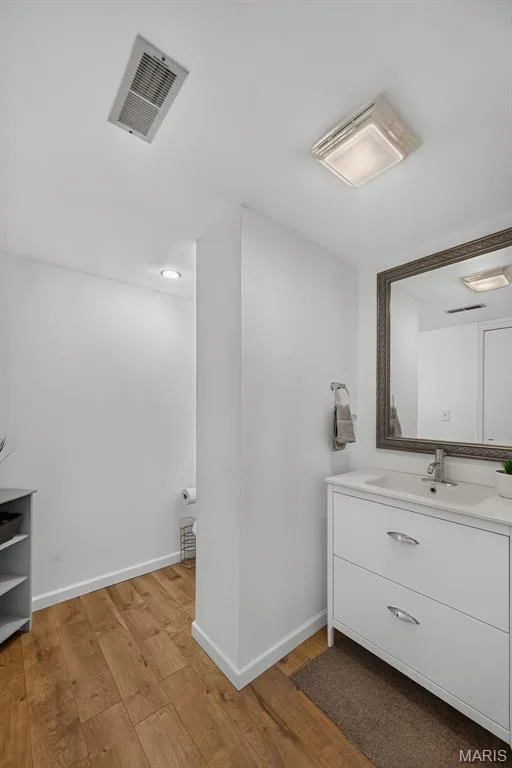Modern bathroom featuring a white vanity with dual drawers and chrome hardware, and a rectangular vessel sink — 23 Crescent Woods Drive, St Peters, MO 63376