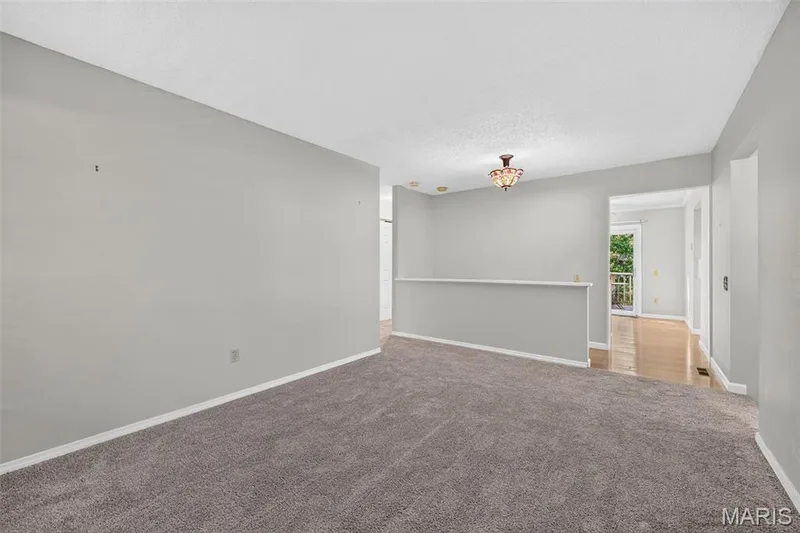 Carpeted flooring with painted walls, recessed lighting, and a decorative ceiling fixture — 1319 Brandywine Lane, St Peters, MO 63376