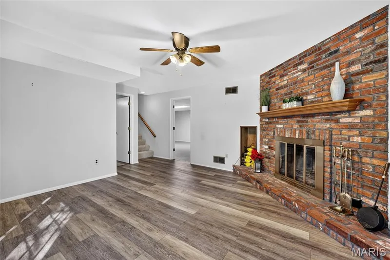 Brick-faced fireplace with a wood mantel — 1319 Brandywine Lane, St Peters, MO 63376