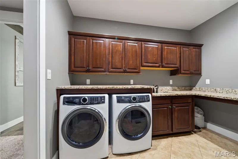 Main floor laundry room with granite counters and sink — 1950 Diehr Road, Wentzville, MO 63385