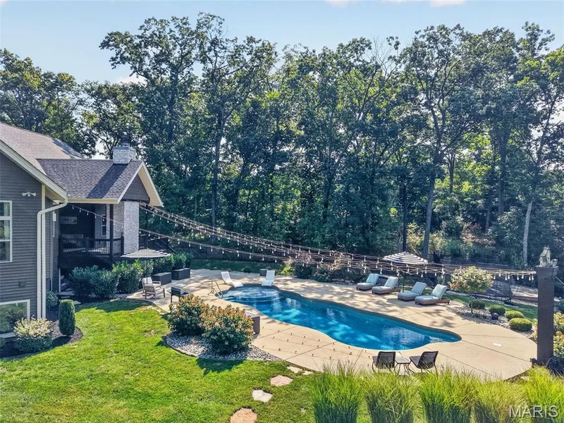 A view from the back with patio surrounding pool — 1950 Diehr Road, Wentzville, MO 63385