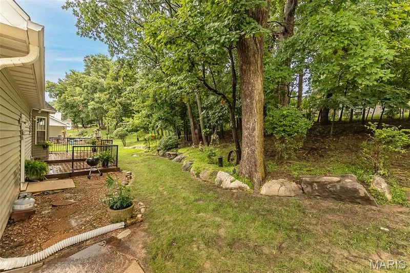 Sit on your back patio with views of trees and watch deer cross the backyard. — 868 Natchez Drive, St Charles, MO 63303