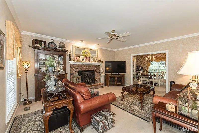 The family room features a cozy fireplace and flows seamlessly into the formal dining room. — 868 Natchez Drive, St Charles, MO 63303