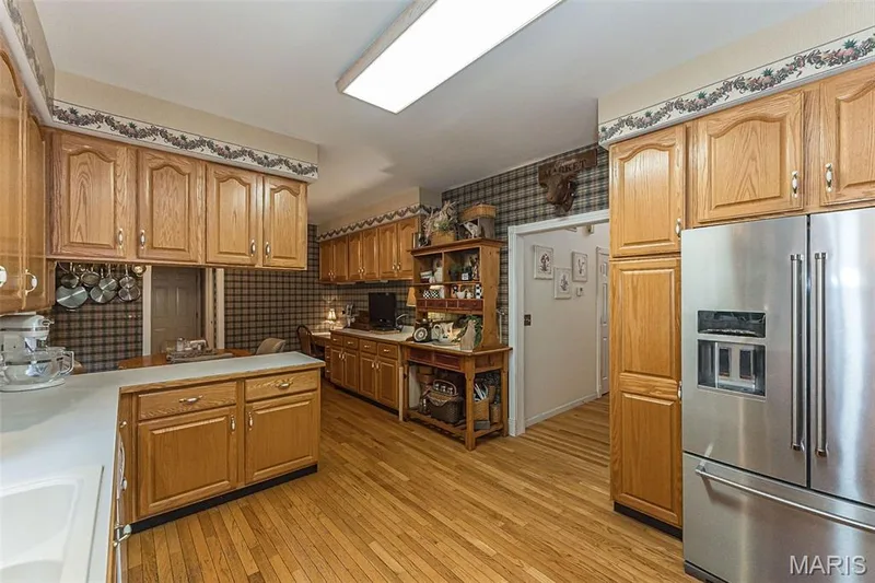 Don't miss the pantry cabinets around the fridge! — 868 Natchez Drive, St Charles, MO 63303