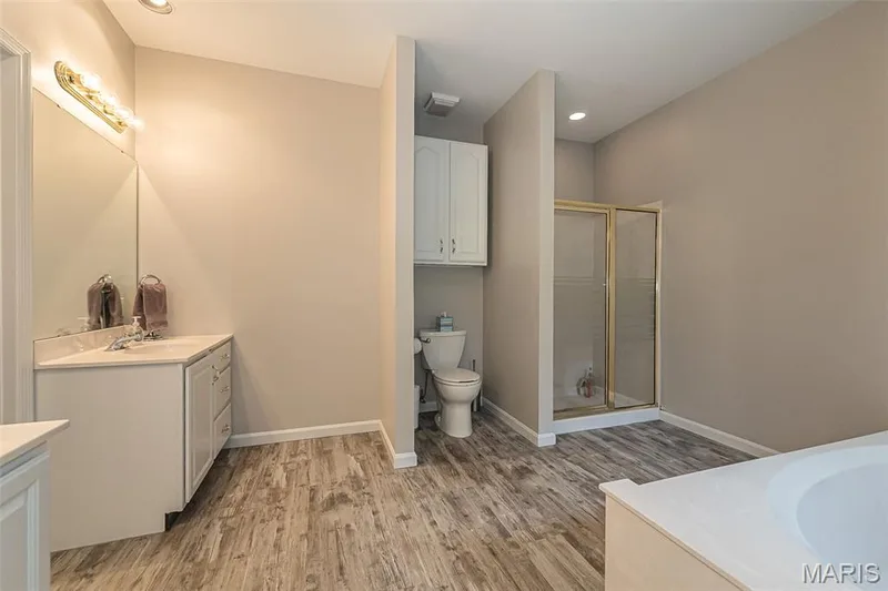Oversized primary bath features soaking tub, shower and separate vanities. — 868 Natchez Drive, St Charles, MO 63303