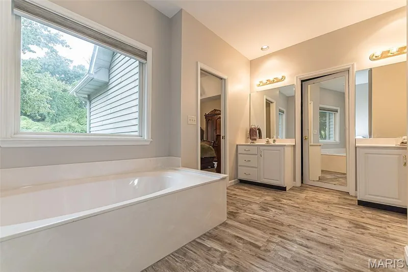 Walk in closet between the vanities. — 868 Natchez Drive, St Charles, MO 63303