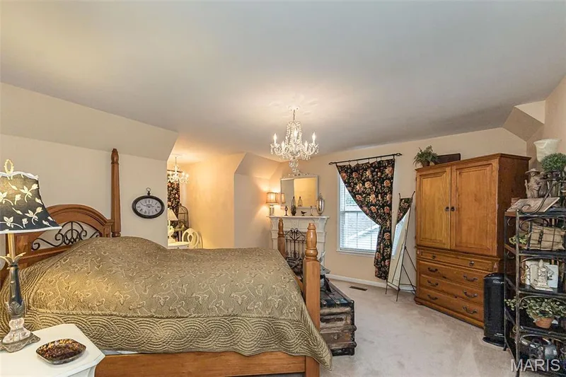 Bedroom 2 is generously sized and features 2 more chandeliers! — 868 Natchez Drive, St Charles, MO 63303