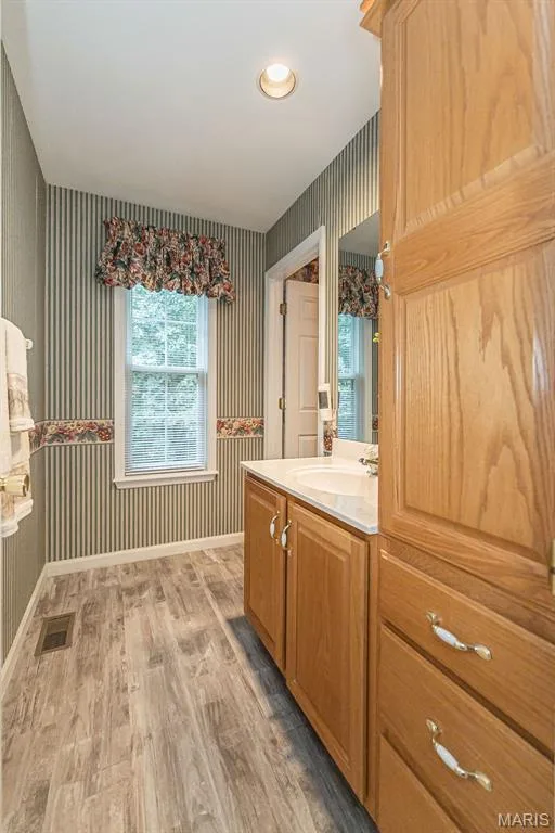 The upstairs bedrooms share a Jack and Jill bathroom with separate vanity rooms. — 868 Natchez Drive, St Charles, MO 63303
