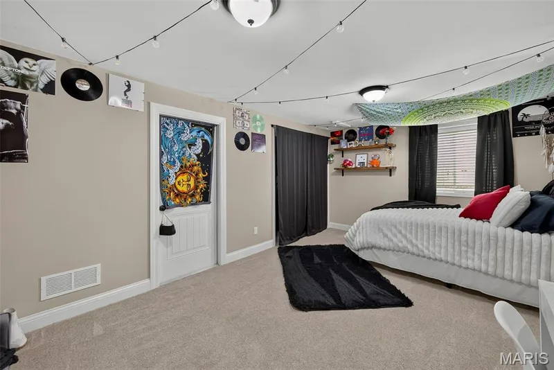 4th bedroom with egress window and closet. Closet doors are stored in the unfinished area (current occupant prefers a curtain instead) — 103 Pomodora Circle, Wentzville, MO 63385