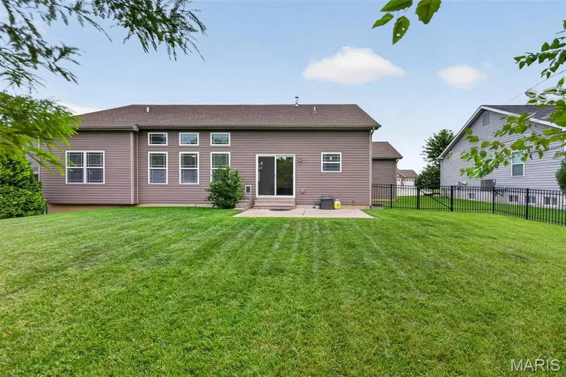 This is the definition of LEVEL YARD! Fully fence with irrigation system, expansive landscaping and greenscape — 103 Pomodora Circle, Wentzville, MO 63385