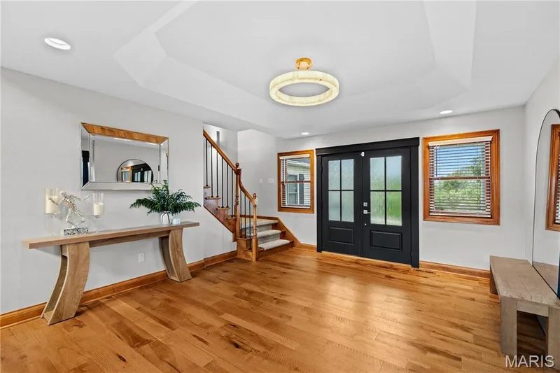 Hardwood flooring, recessed lighting, double entry doors with frosted glass, wood-framed windows, and a coffered ceiling — 205 Howell Road, Defiance, MO 63341
