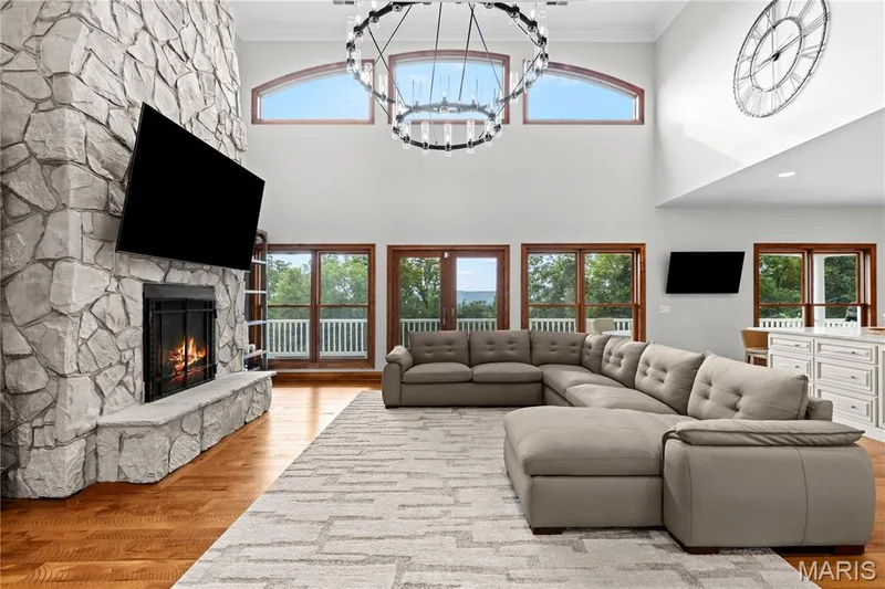 Vaulted ceiling with decorative lighting and upper arched windows — 205 Howell Road, Defiance, MO 63341