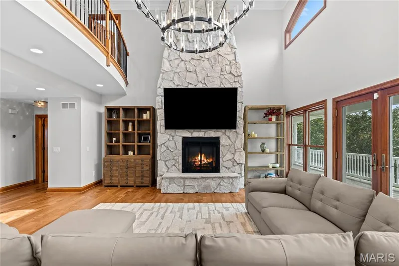 Soaring ceilings with a stone-clad fireplace and a built-in firebox — 205 Howell Road, Defiance, MO 63341