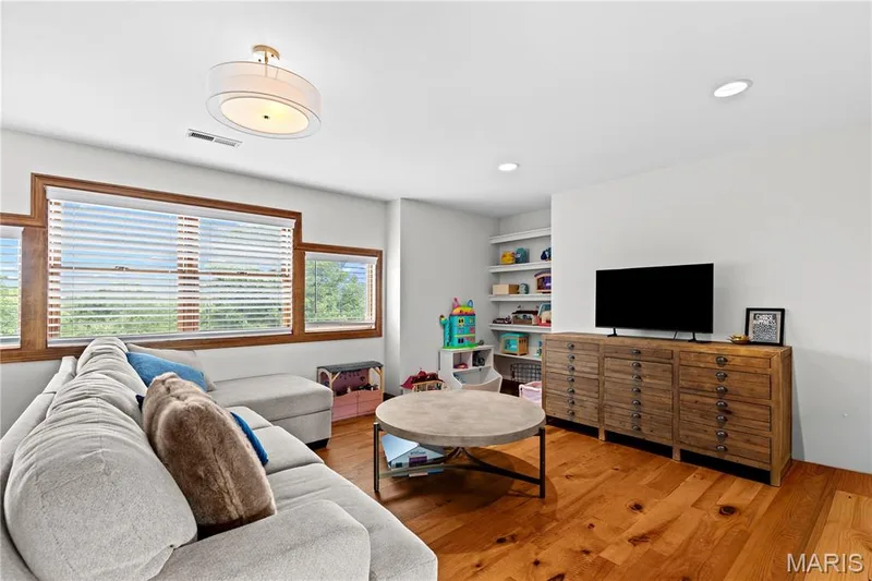 Hardwood flooring, recessed lighting, built-in shelving, wood-framed windows, and a semi-flush mount ceiling light — 205 Howell Road, Defiance, MO 63341