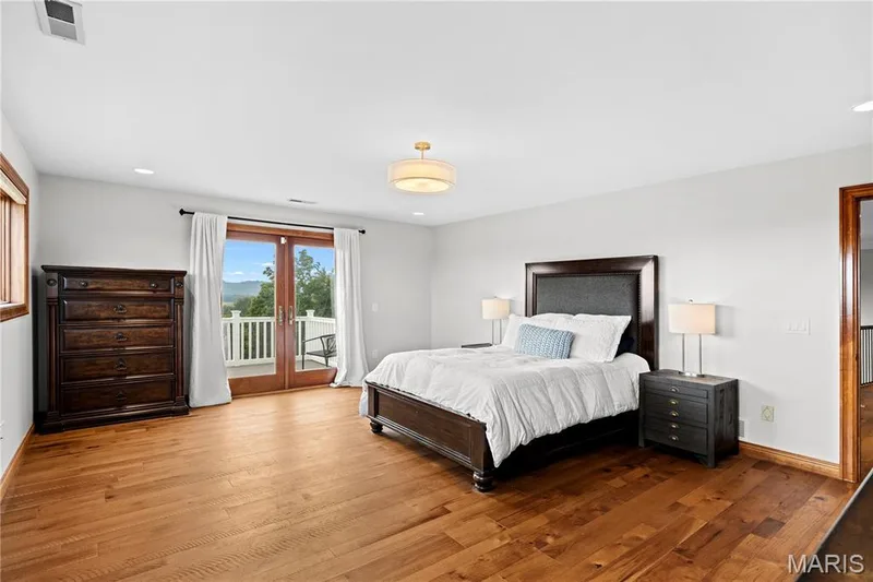 Hardwood flooring throughout, recessed lighting, and a drum pendant light fixture — 205 Howell Road, Defiance, MO 63341