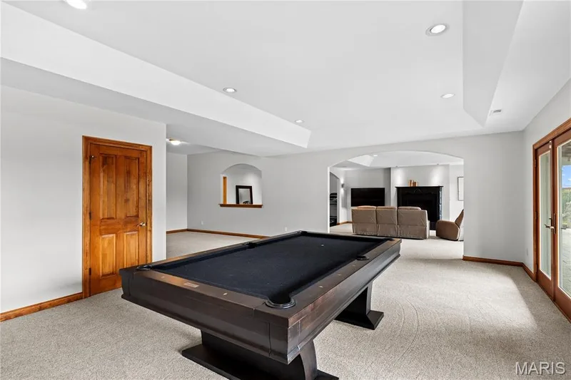 Carpeted room with recessed lighting and a wood-finish door — 205 Howell Road, Defiance, MO 63341