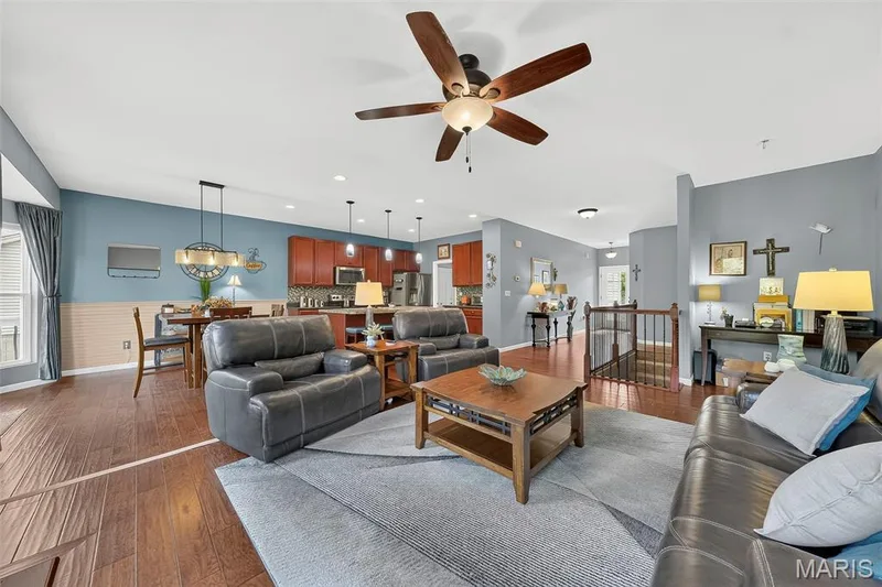The living room offers an open concept with beautiful hardwood floors and 9 ft ceilings throughout the home. — 1125 Crystal Creek Parkway, Wentzville, MO 63385