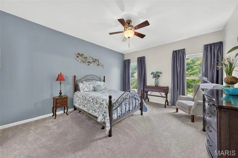The primary bedroom is bright with plenty of natural light.  A ceiling fan completes this space. — 1125 Crystal Creek Parkway, Wentzville, MO 63385