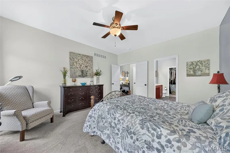 The primary bedroom offers an ensuite with walk-in closet. — 1125 Crystal Creek Parkway, Wentzville, MO 63385