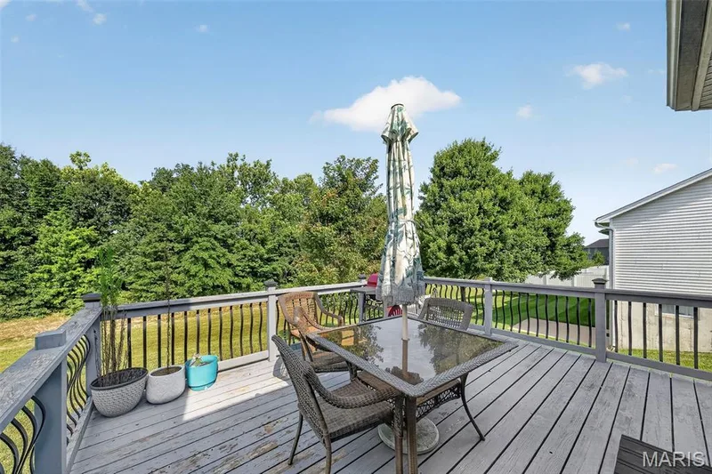 Relax on the deck that overlooks the spacious back yard. — 1125 Crystal Creek Parkway, Wentzville, MO 63385