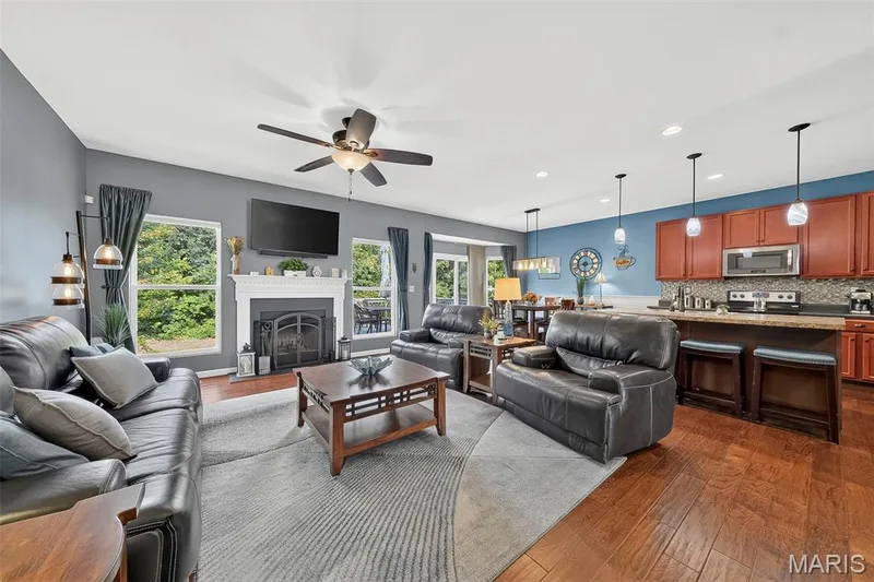 Hardwood floors and ceiling fan complete this space. — 1125 Crystal Creek Parkway, Wentzville, MO 63385