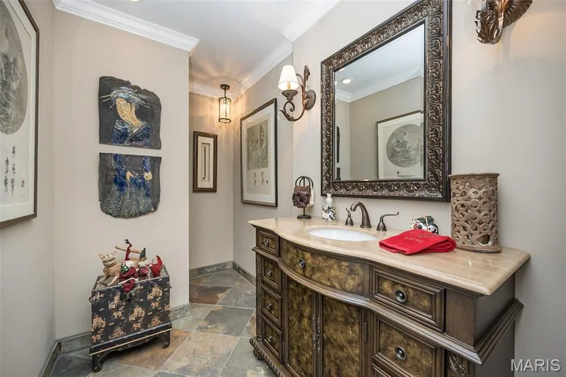 Bathroom with vanity, crown molding, and stone tile floors — 1512 Bedford Forge Court #19, Chesterfield, MO 63017