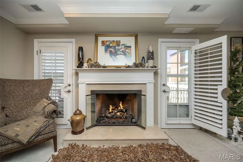 Gas fireplace is flanked by atrium doors to composite deck. — 1512 Bedford Forge Court #19, Chesterfield, MO 63017