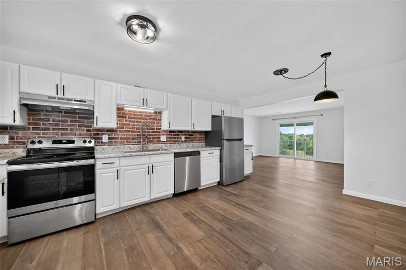 Updated kitchen space with newer countertops, painted cabinets, SS appliances — 1823 Gascony Parc Drive #1823, Lake St. Louis, MO 63367