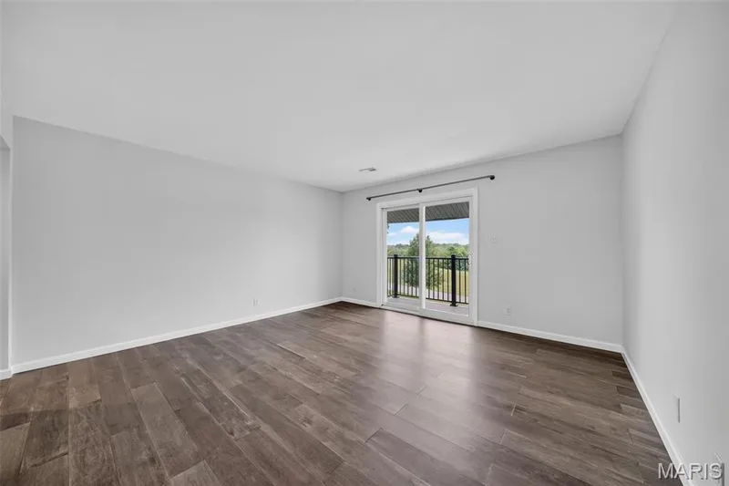 Large living room with tons of natural light from the outdoor balcony — 1823 Gascony Parc Drive #1823, Lake St. Louis, MO 63367
