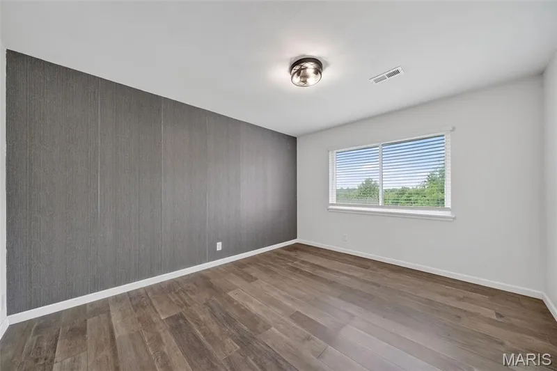 Large windows, accent wall, and nice size closet — 1823 Gascony Parc Drive #1823, Lake St. Louis, MO 63367