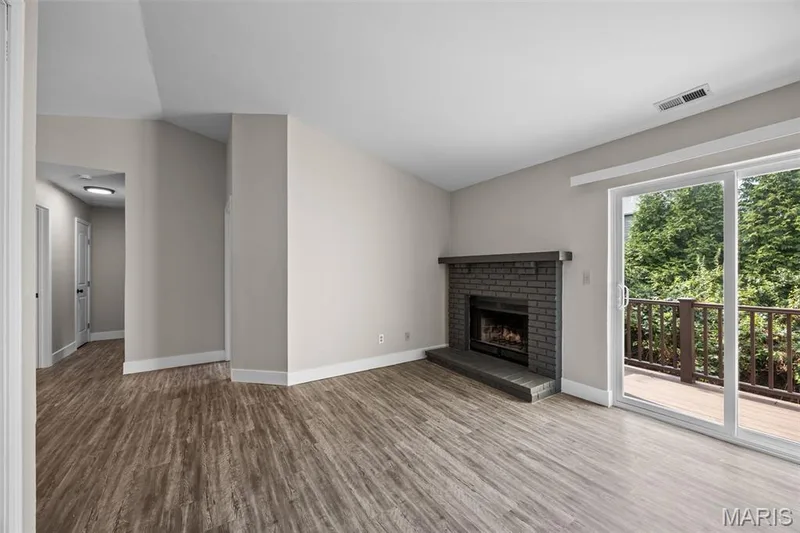 Living Room features all new flooring, wood burning fireplace and vaulted ceiling. — 2419 Sandalwood Creek Court #F, Wildwood, MO 63038