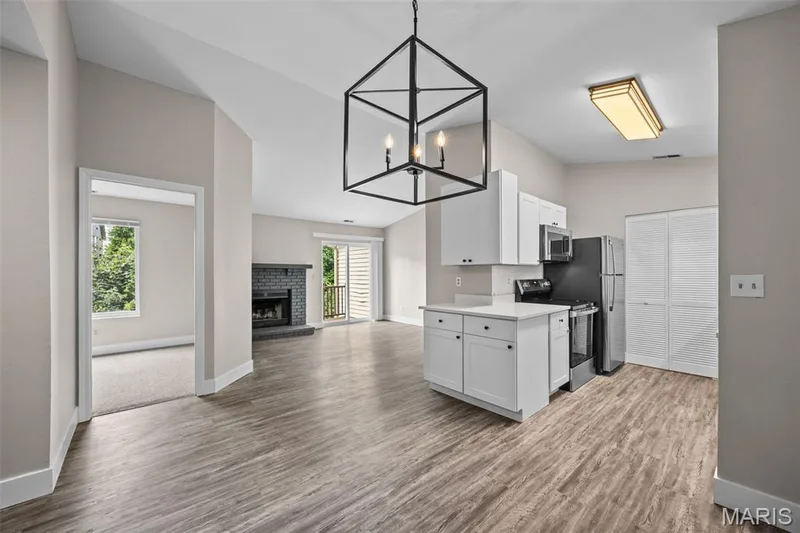 View from Dining Room into Kitchen and Living Room — 2419 Sandalwood Creek Court #F, Wildwood, MO 63038