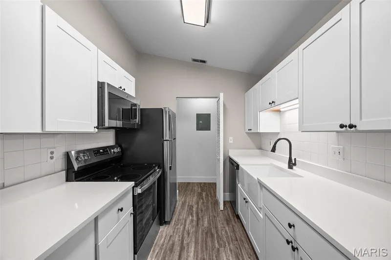 Kitchen boasts new cabinets, granite countertops and new appliances. — 2419 Sandalwood Creek Court #F, Wildwood, MO 63038