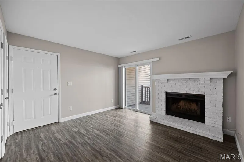 Living Room with new flooring and wood burning fireplace. — 2343 Sandalwood Creek Court #C, Wildwood, MO 63038