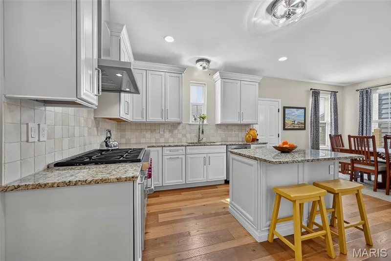 Kitchen Remodeled in 2020 With Engineered Hardwood, 42" Cabinets, Granite Countertops, Wolf Gas Stove with Wolf Hood, Double Door Bosch Refrigerator, and Bosch Dishwasher. — 3253 Camp Street, St Charles, MO 63301