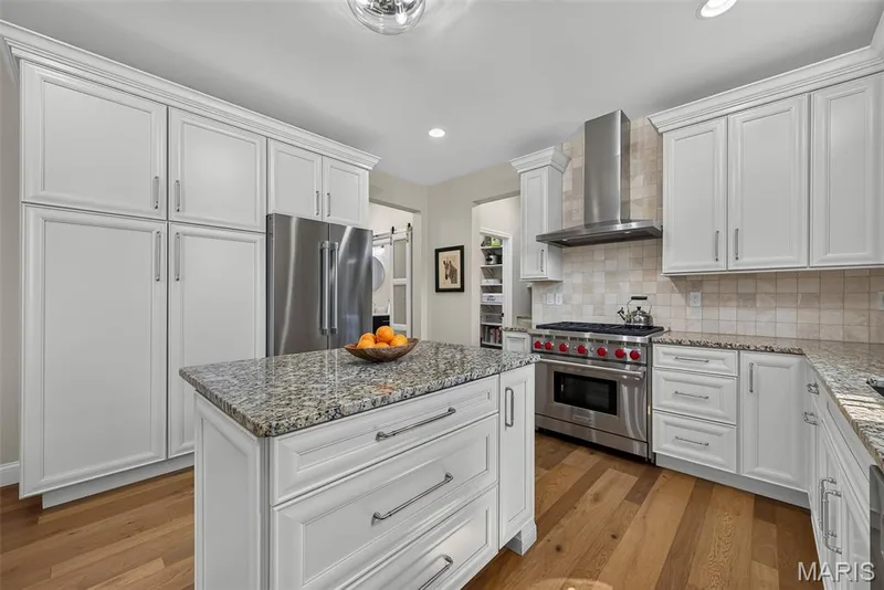 Kitchen Remodeled in 2020 With Engineered Hardwood, 42" Cabinets, Granite Countertops, Wolf Gas Stove with Wolf Hood, Double Door Bosch Refrigerator, and Bosch Dishwasher. — 3253 Camp Street, St Charles, MO 63301
