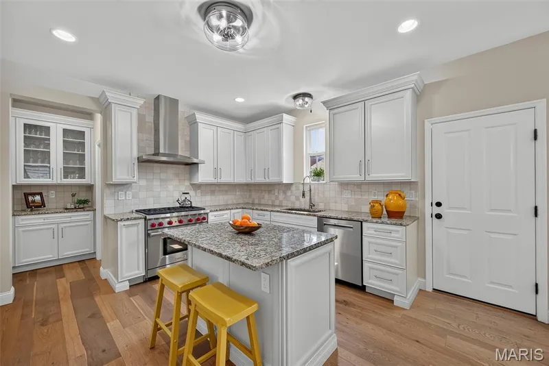Kitchen Remodeled in 2020 With Engineered Hardwood, 42" Cabinets, Granite Countertops, Wolf Gas Stove with Wolf Hood, Double Door Bosch Refrigerator, and Bosch Dishwasher. — 3253 Camp Street, St Charles, MO 63301