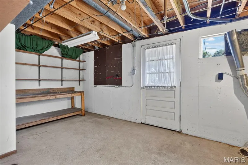 Laundry/storage area with walk out to back yard patio — 16 Saint Michael Drive, St Peters, MO 63376