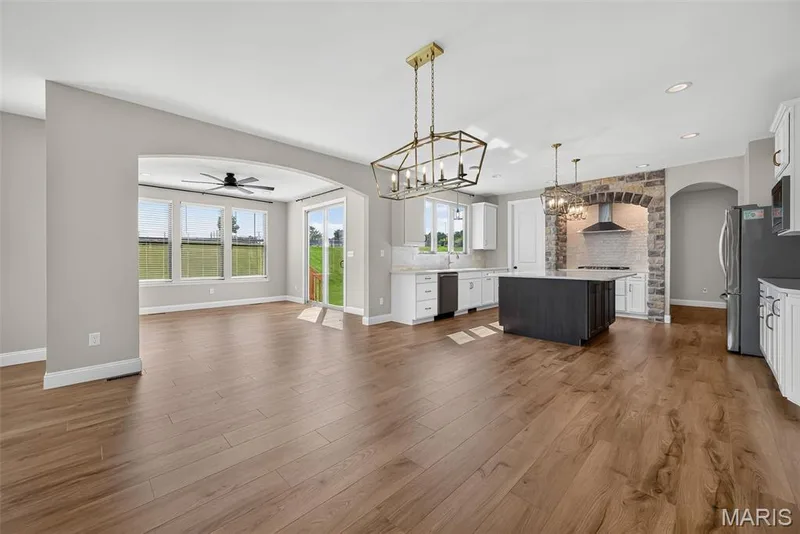 Breakfast Room, Sun/Hearth Room and Kitchen with 9 Foot Ceilings and Luxury Vinyl Plank Flooring — 106 Downview Drive, O'Fallon, MO 63368