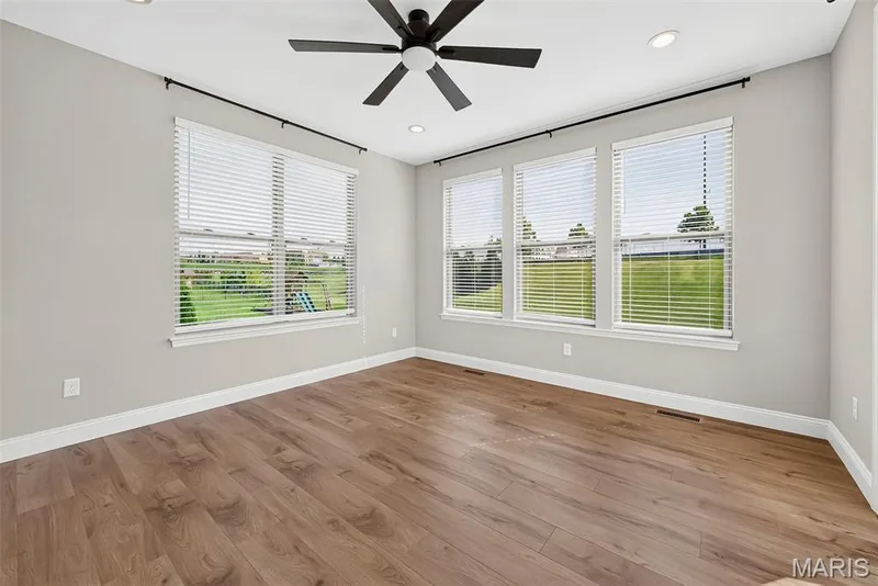 9 Foot Ceilings and Luxury Vinyl Plank Flooring in Sun/Hearth Room — 106 Downview Drive, O'Fallon, MO 63368