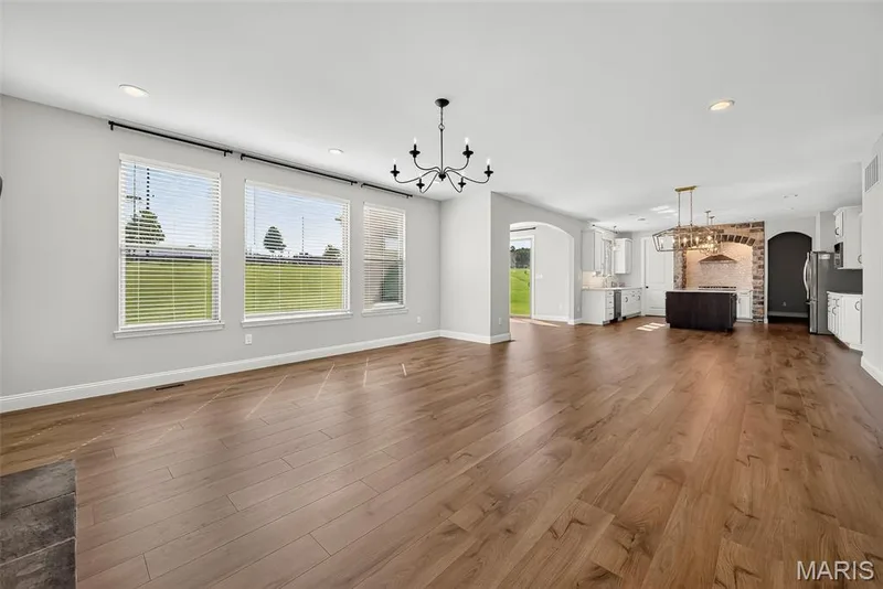 Great Room with 9 Foot Ceilings, Window Wall and Luxury Vinyl Plank Flooring — 106 Downview Drive, O'Fallon, MO 63368