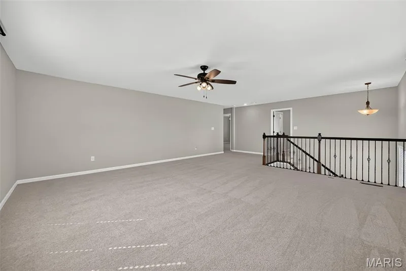 Bonus Room and Staircase with Wrought Iron Spindles — 106 Downview Drive, O'Fallon, MO 63368
