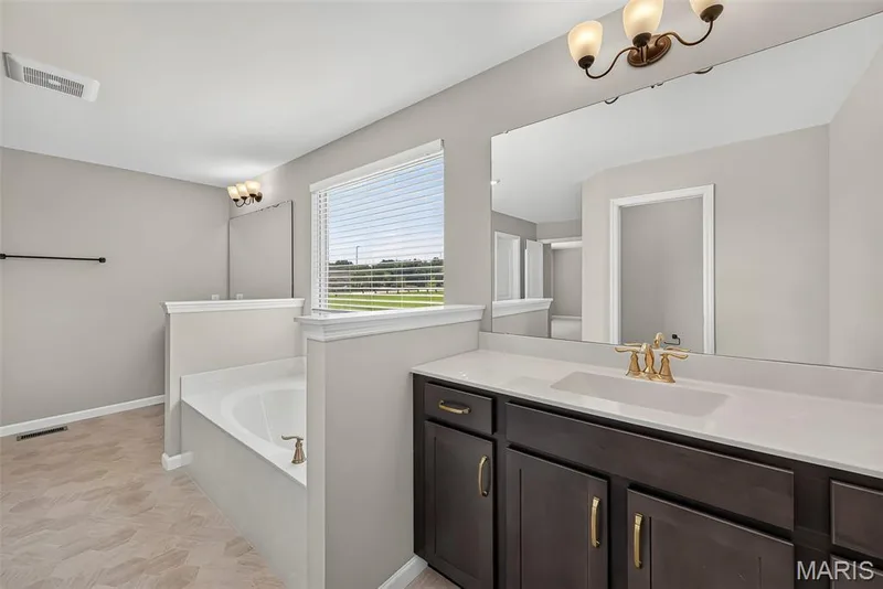 Split Raised Height Vanities and Soaking Tub in Primary Bath — 106 Downview Drive, O'Fallon, MO 63368