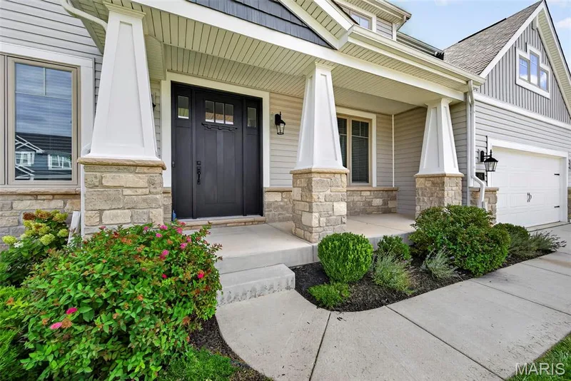 Large Covered Front Porch with Craftsman Style Porch Columns with Stone Bases and a 8 Foot Craftsman Style Front Door — 106 Downview Drive, O'Fallon, MO 63368