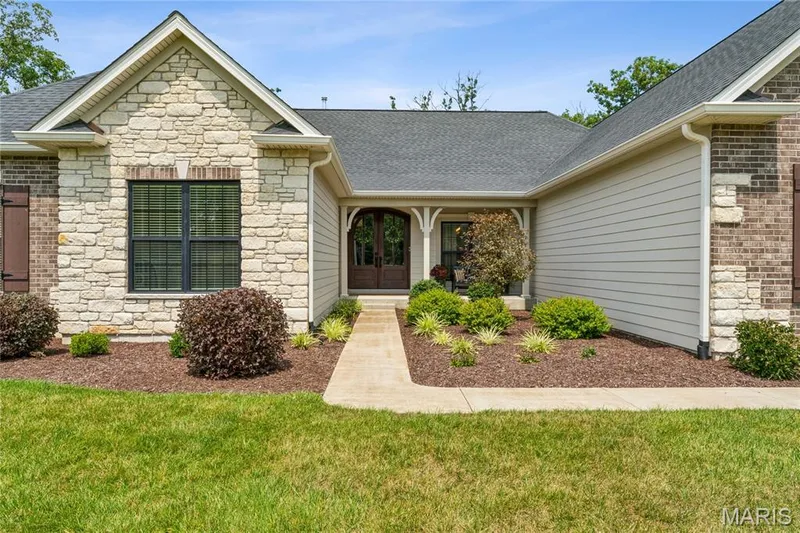 Stone and brick facade with horizontal siding details — 5 Timberdel Place, Foristell, MO 63348