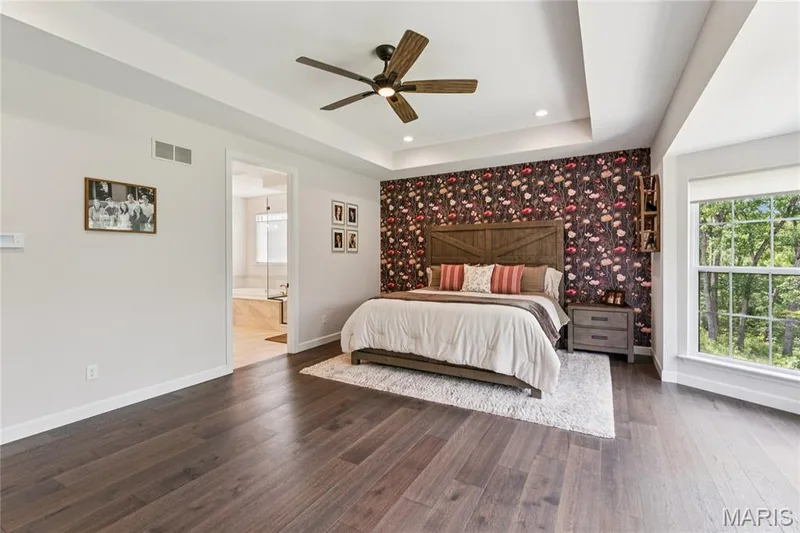 Dark wood-finish flooring, recessed lighting, coffered ceiling, ceiling fan, and large window — 5 Timberdel Place, Foristell, MO 63348