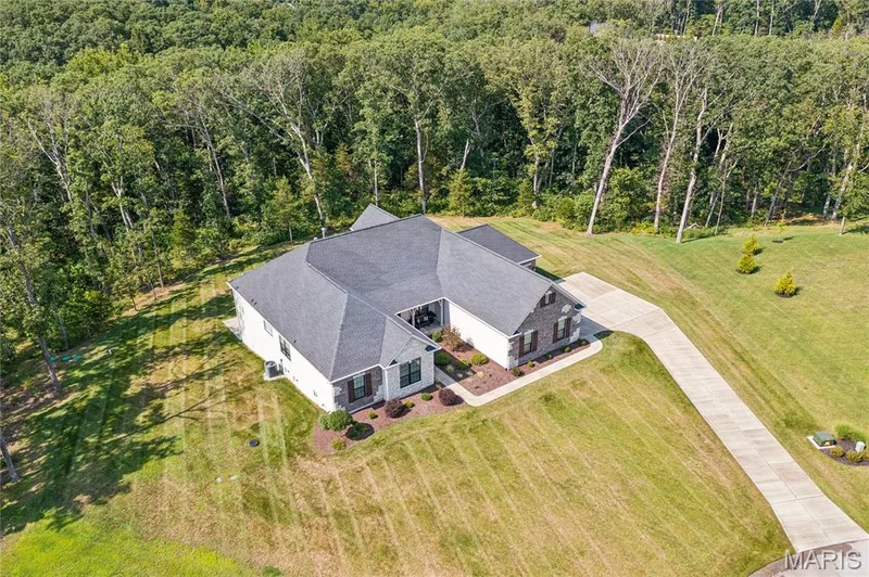 Contemporary 3-acre residence featuring a multi-gabled roofline and a long concrete driveway — 5 Timberdel Place, Foristell, MO 63348