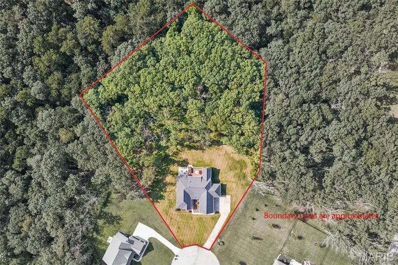 Aerial depiction of a property featuring a single-family residence, mature trees, and a paved driveway — 5 Timberdel Place, Foristell, MO 63348