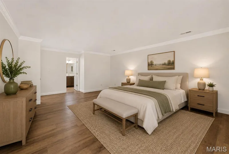 Wood-finish flooring, crown molding, and recessed lighting. Digitally enhanced and virtually staged. — 1608 Lake Knoll Drive #1A, Lake St. Louis, MO 63367
