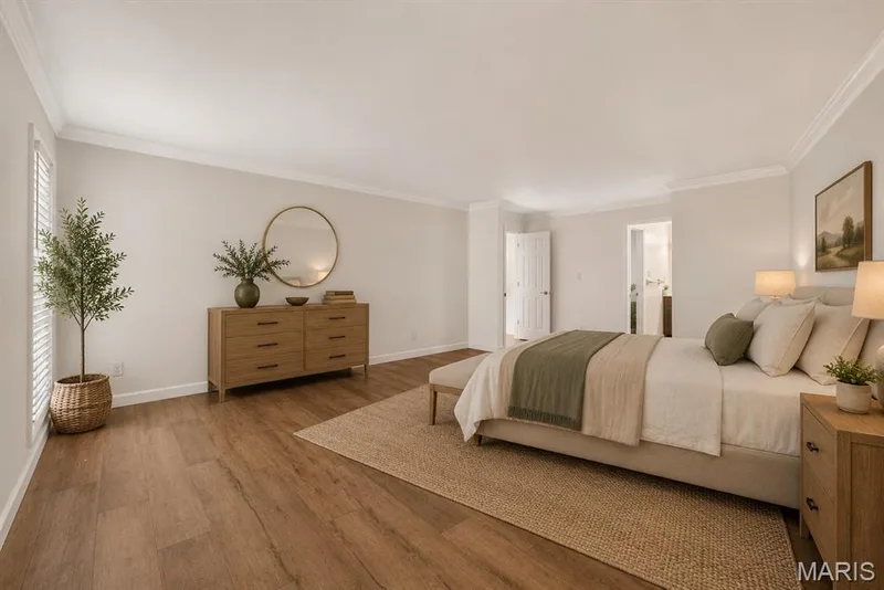 Crown molding throughout, wood-finish flooring. Digitally enhanced and virtually staged.shutters, and a recessed doorway — 1608 Lake Knoll Drive #1A, Lake St. Louis, MO 63367